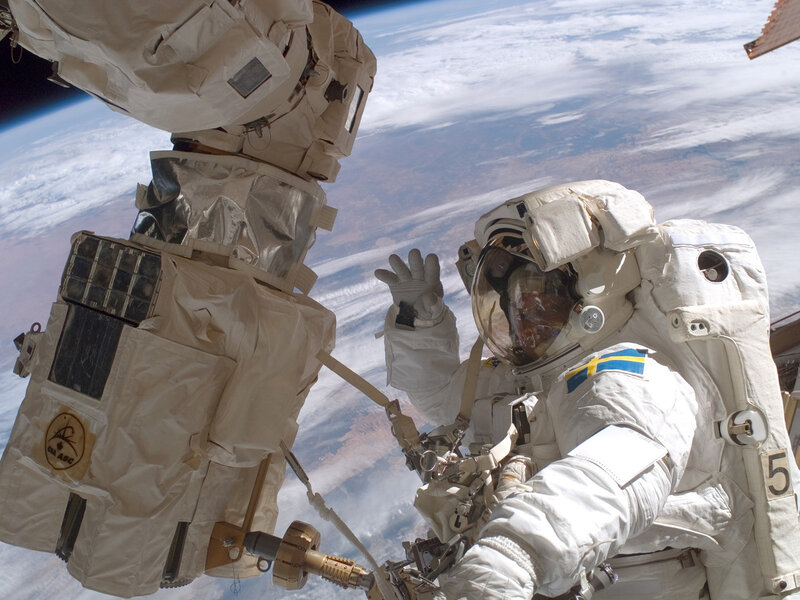 Astronaut in Space Suit — White, Dramatic, Photograph, Space Station, Earth, Clouds, Blue, Brown