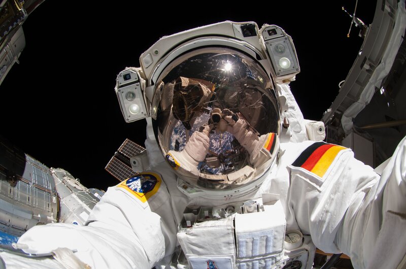 Astronaut in Space Suit — White, Dramatic, Photograph, Space Station, Earth, Helmet, German Flag