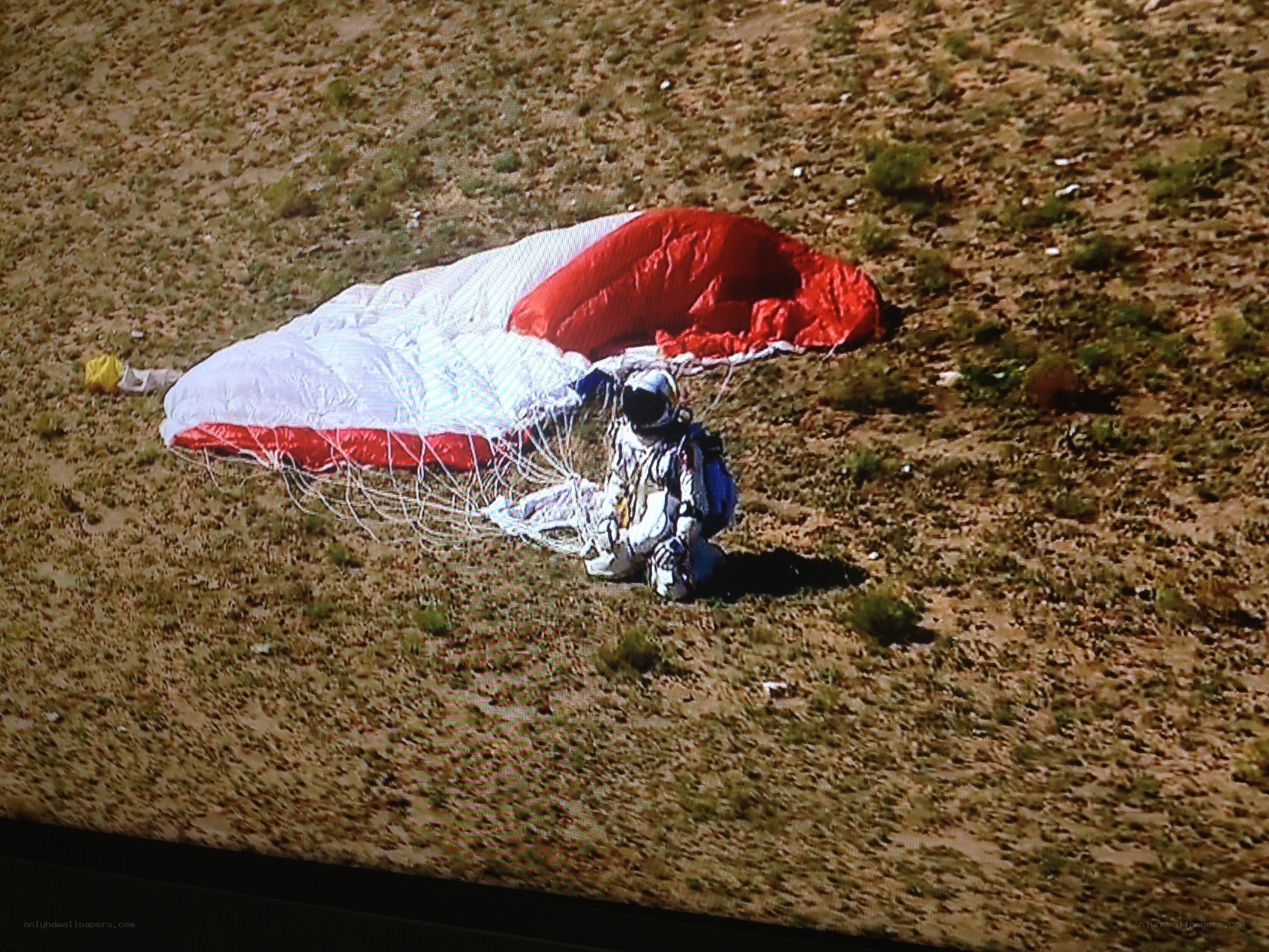 astronaut landing with parachute