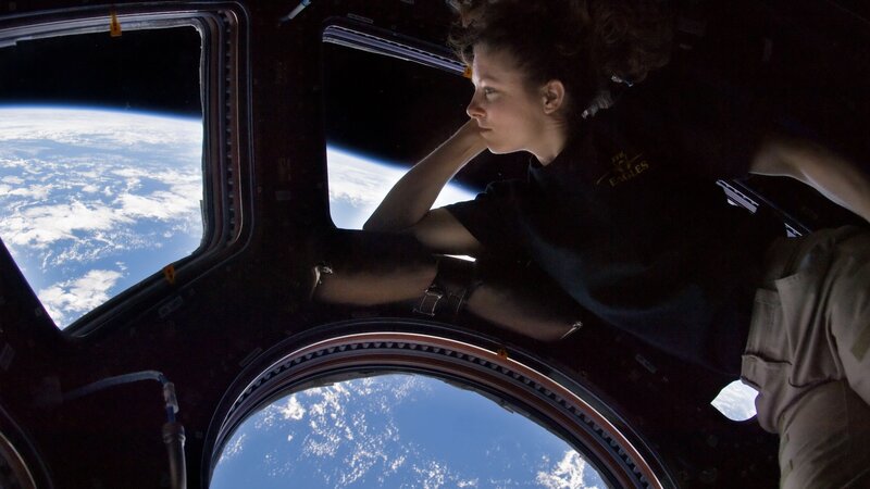 Astronaut Looking Out Window — Blue