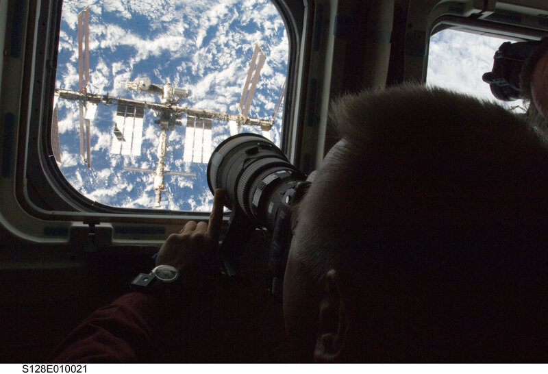 Astronaut photographing space station