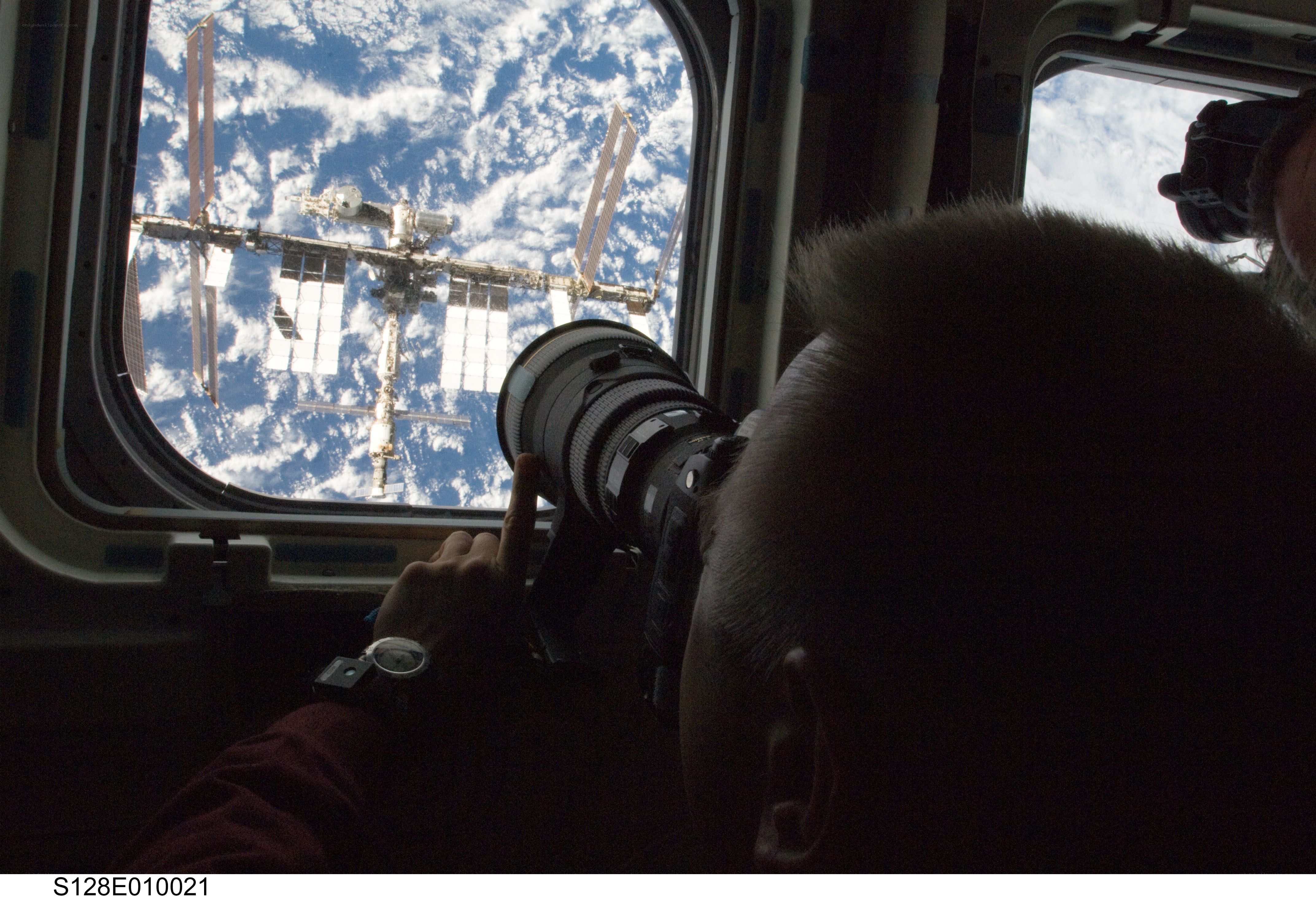 Astronaut photographing space station