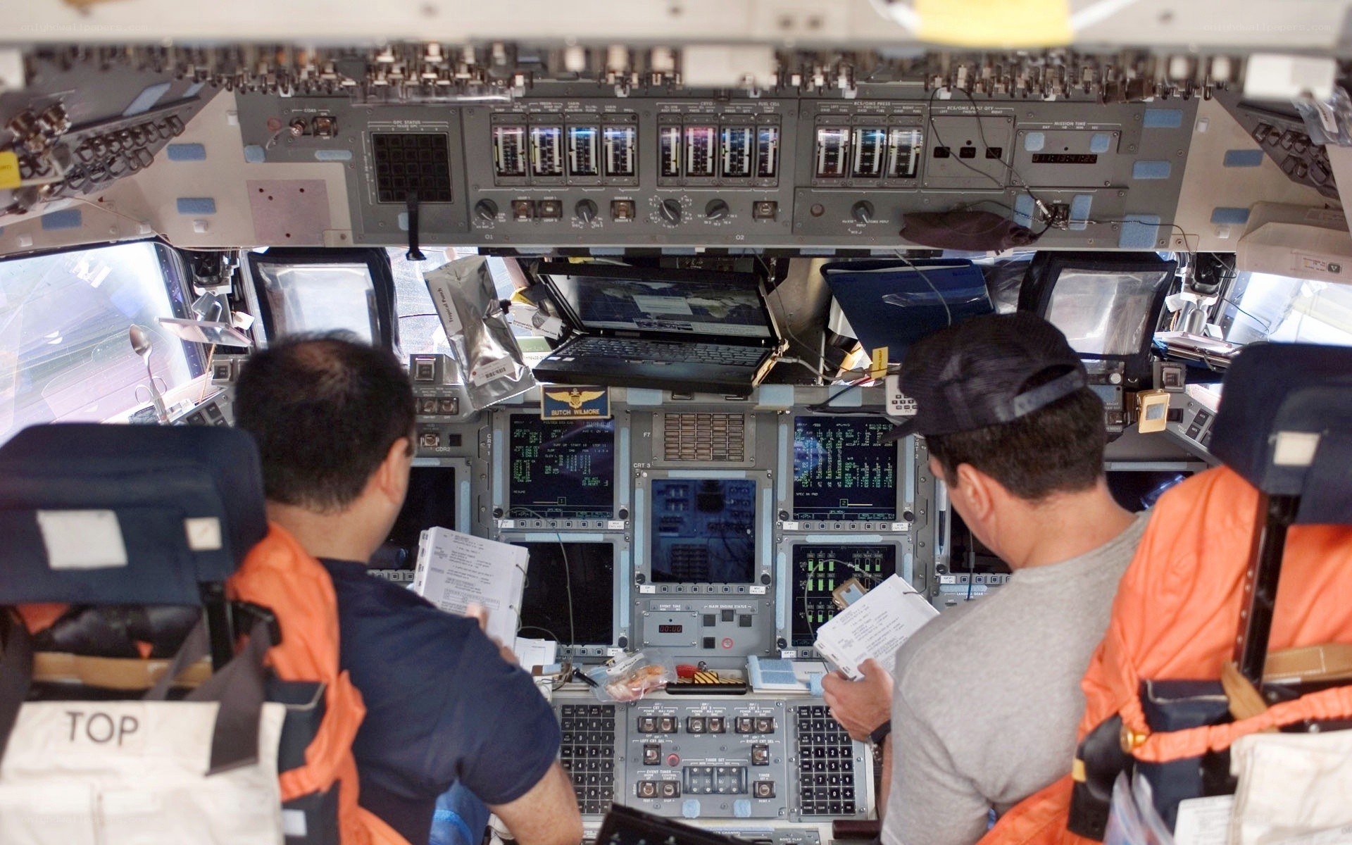 Astronauts in a spacecraft cockpit