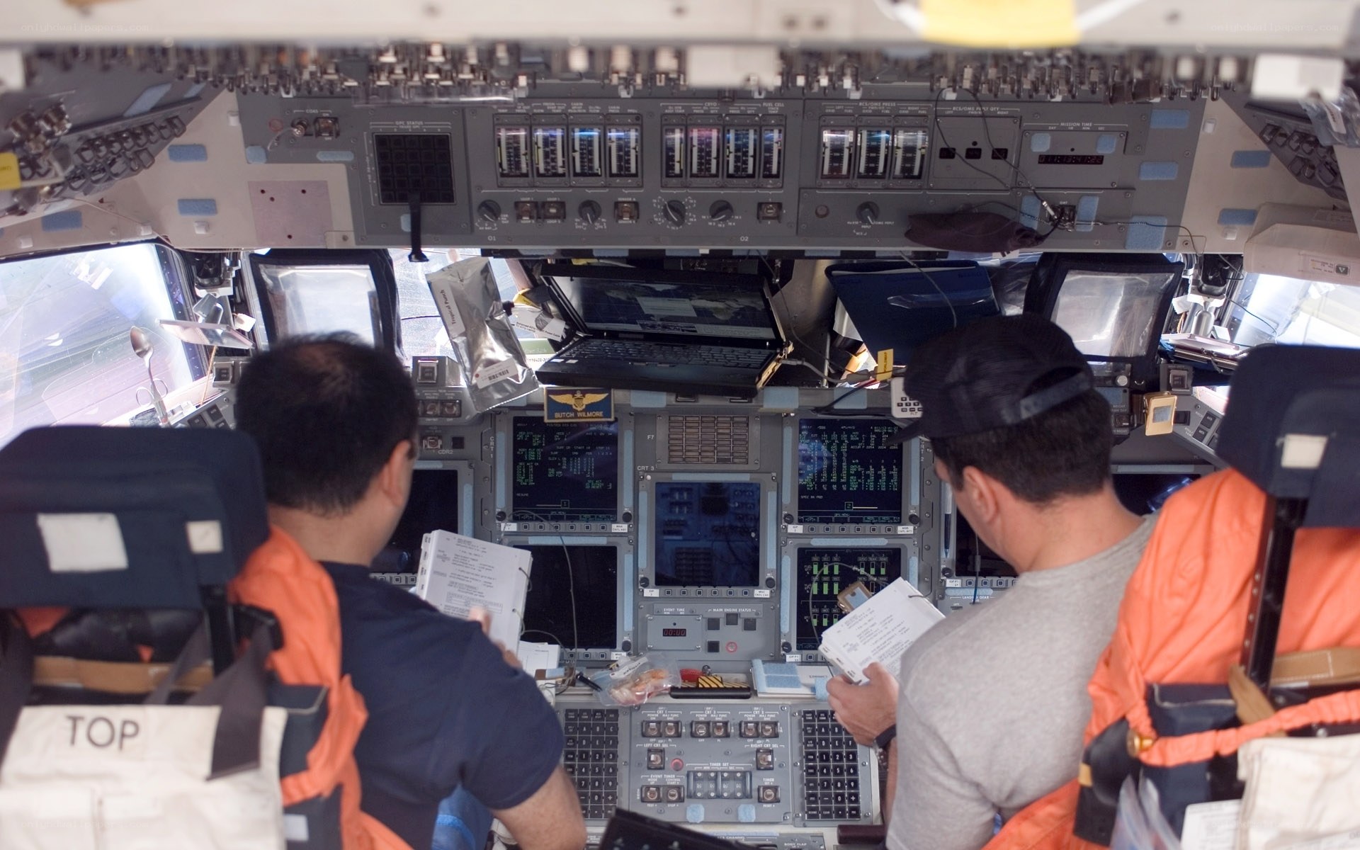 Astronauts in a spacecraft cockpit