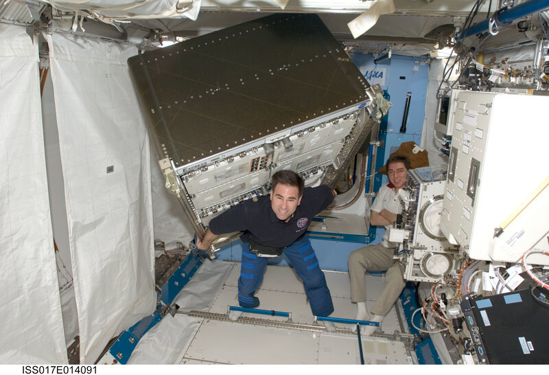 Astronauts in space station module