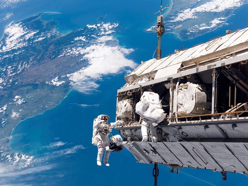 Astronauts on Spacewalk — Clouds