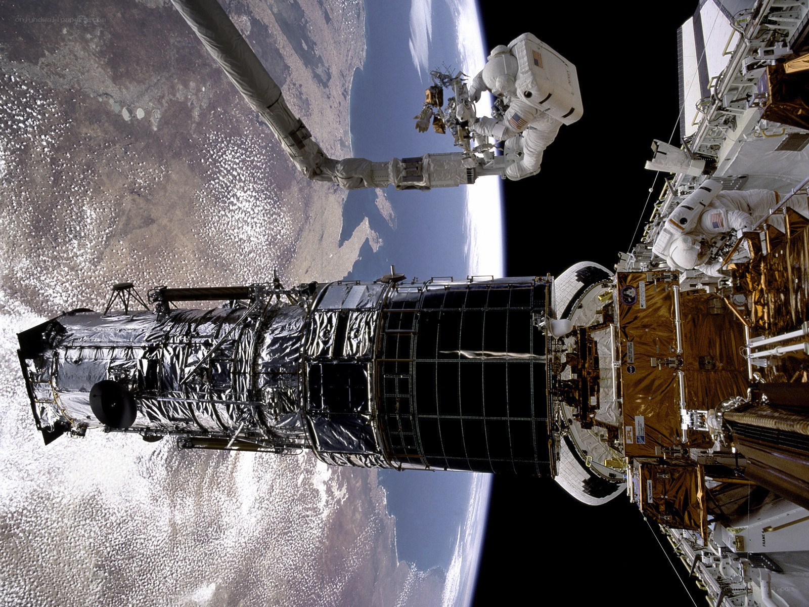 Astronauts servicing a space telescope