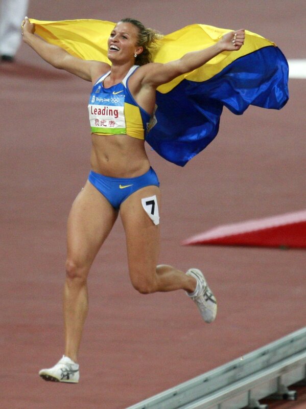 athlete celebrating with flag