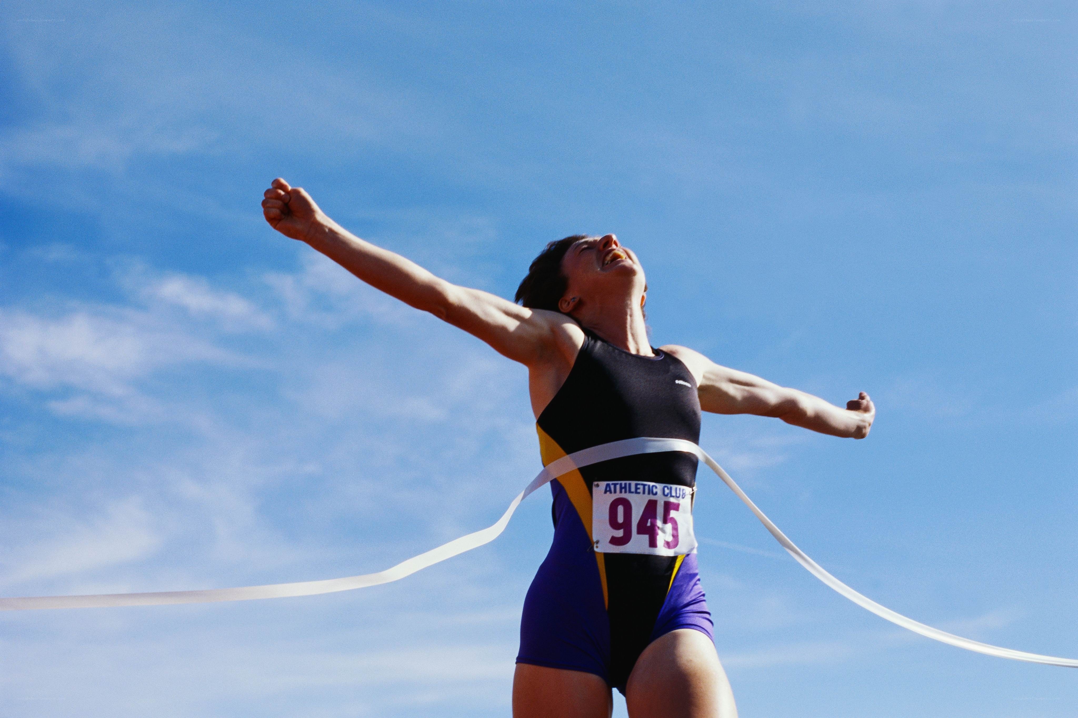 athlete crossing finish line