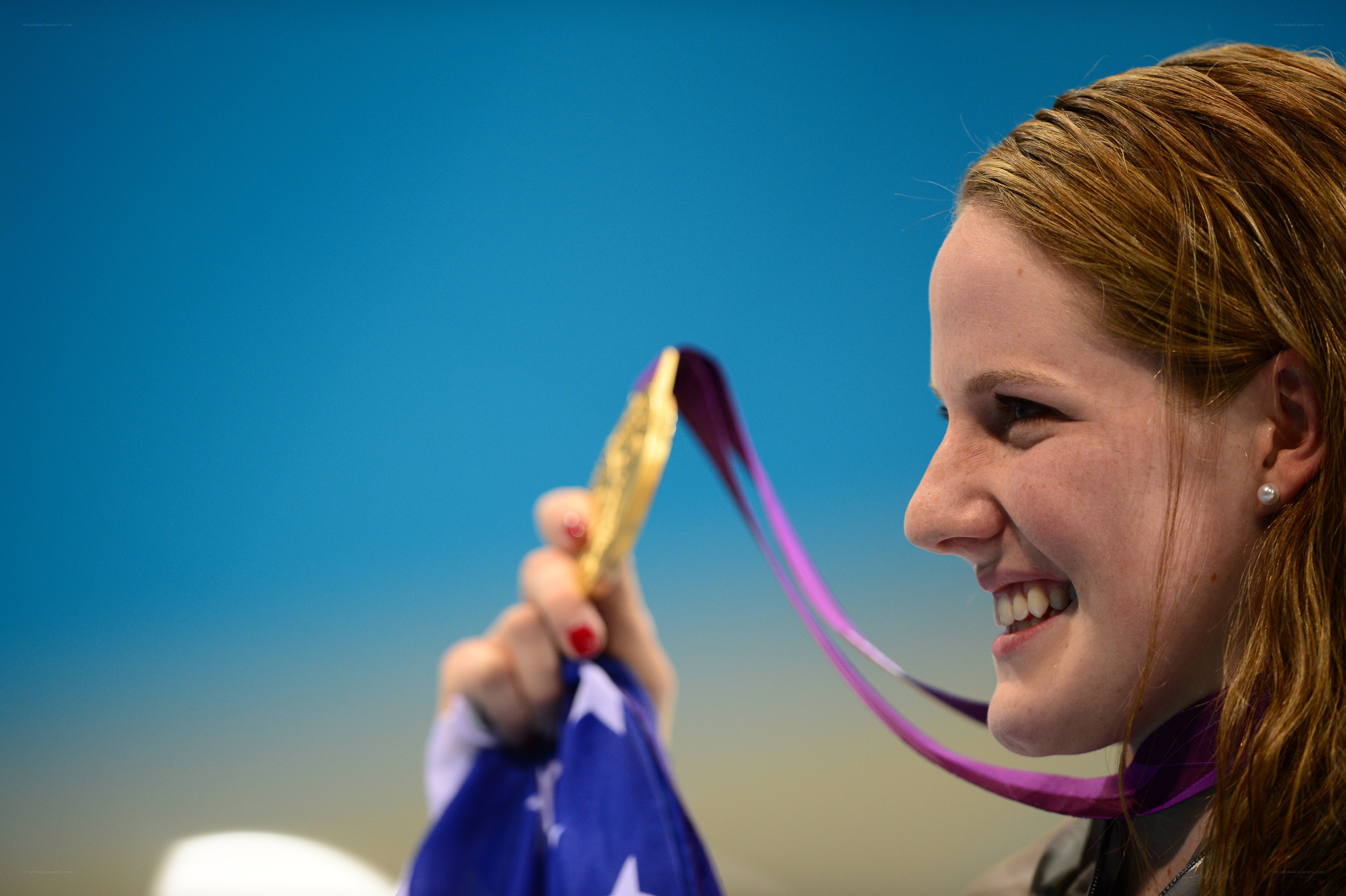 athlete holding gold medal