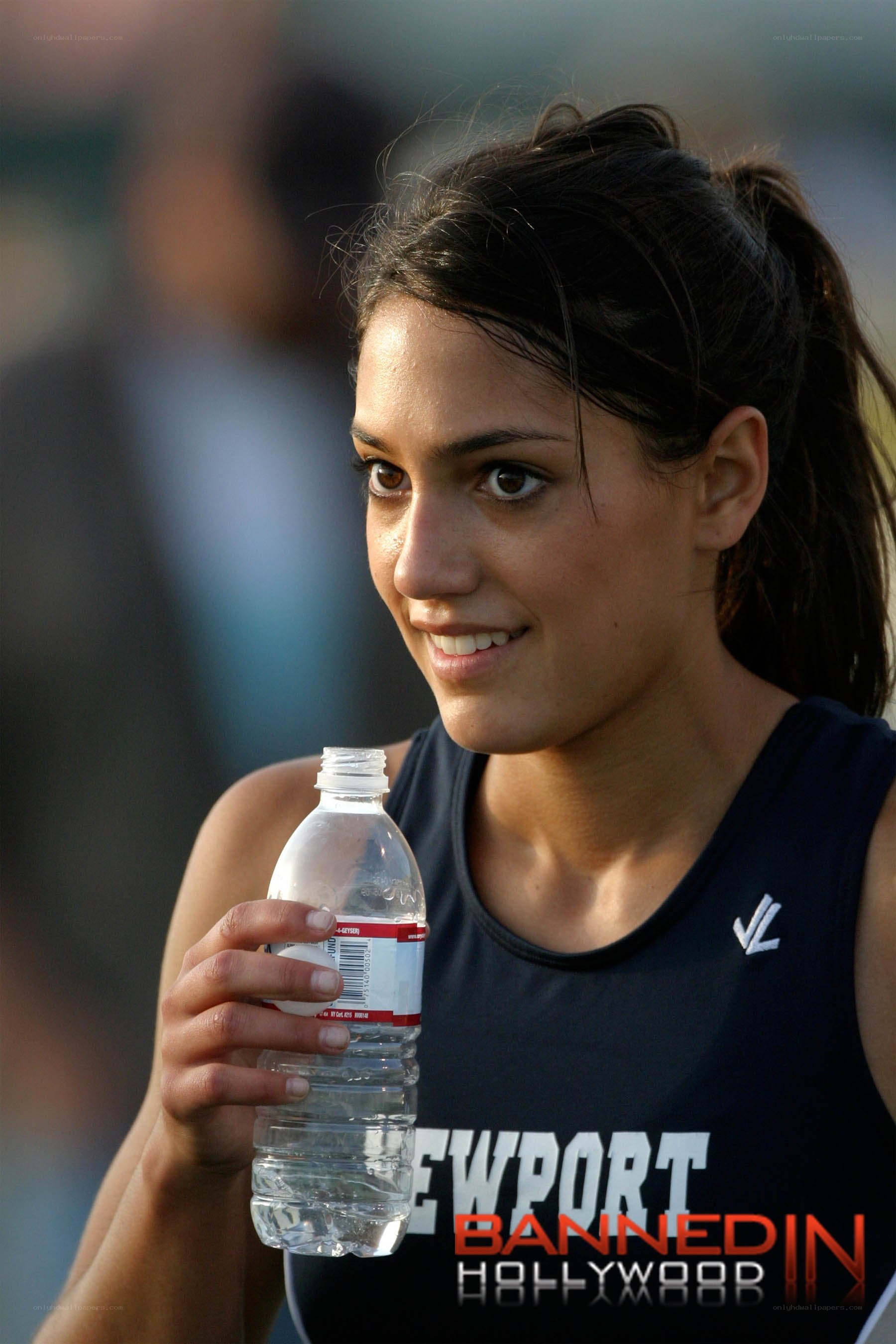 athlete holding water bottle