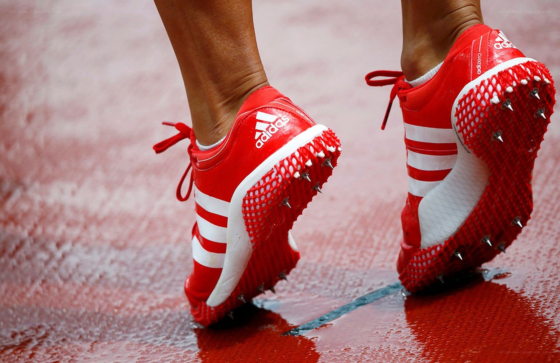 athlete in red track shoes