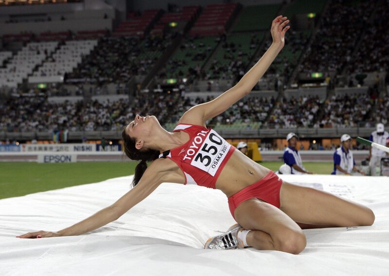 Athlete in red uniform on landing mat