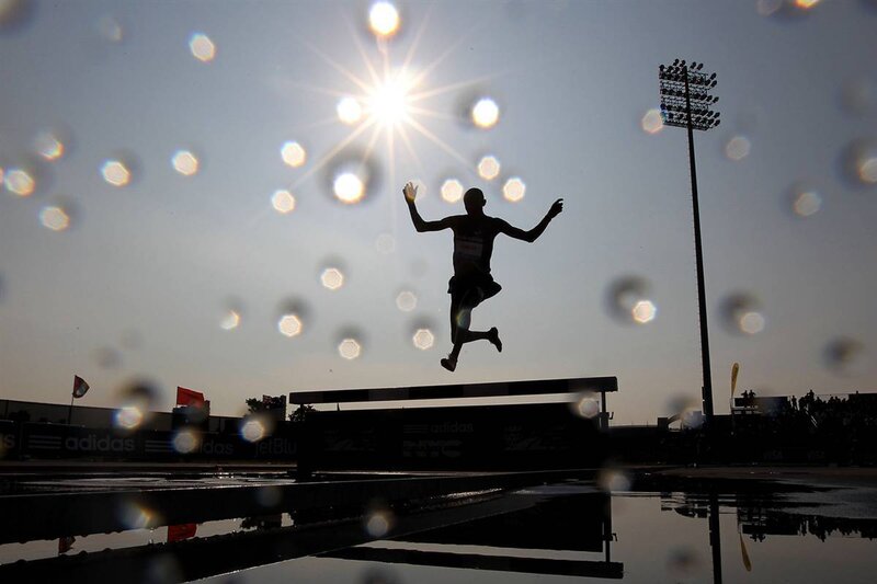 athlete jumping hurdles