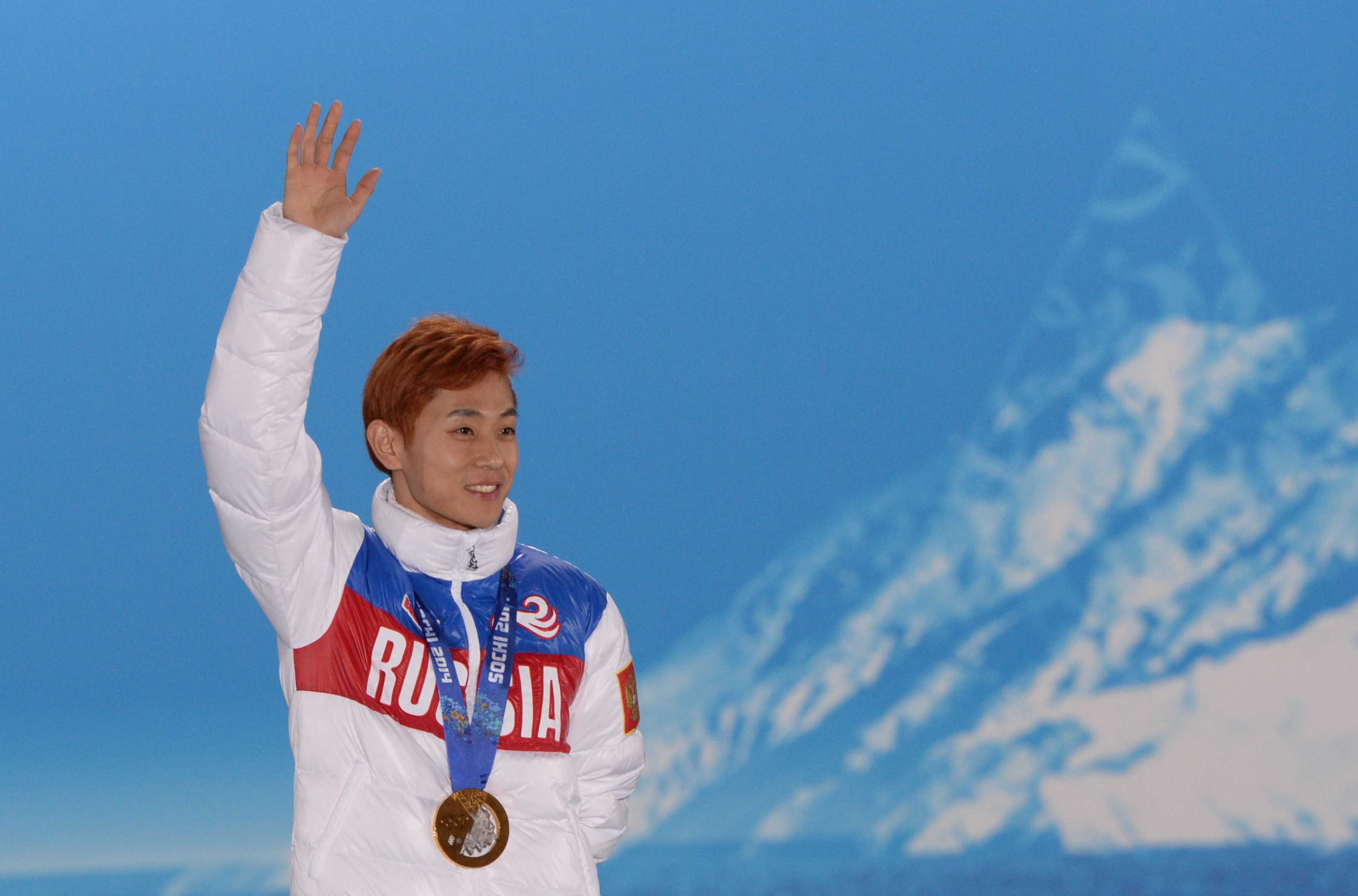 athlete on podium waving