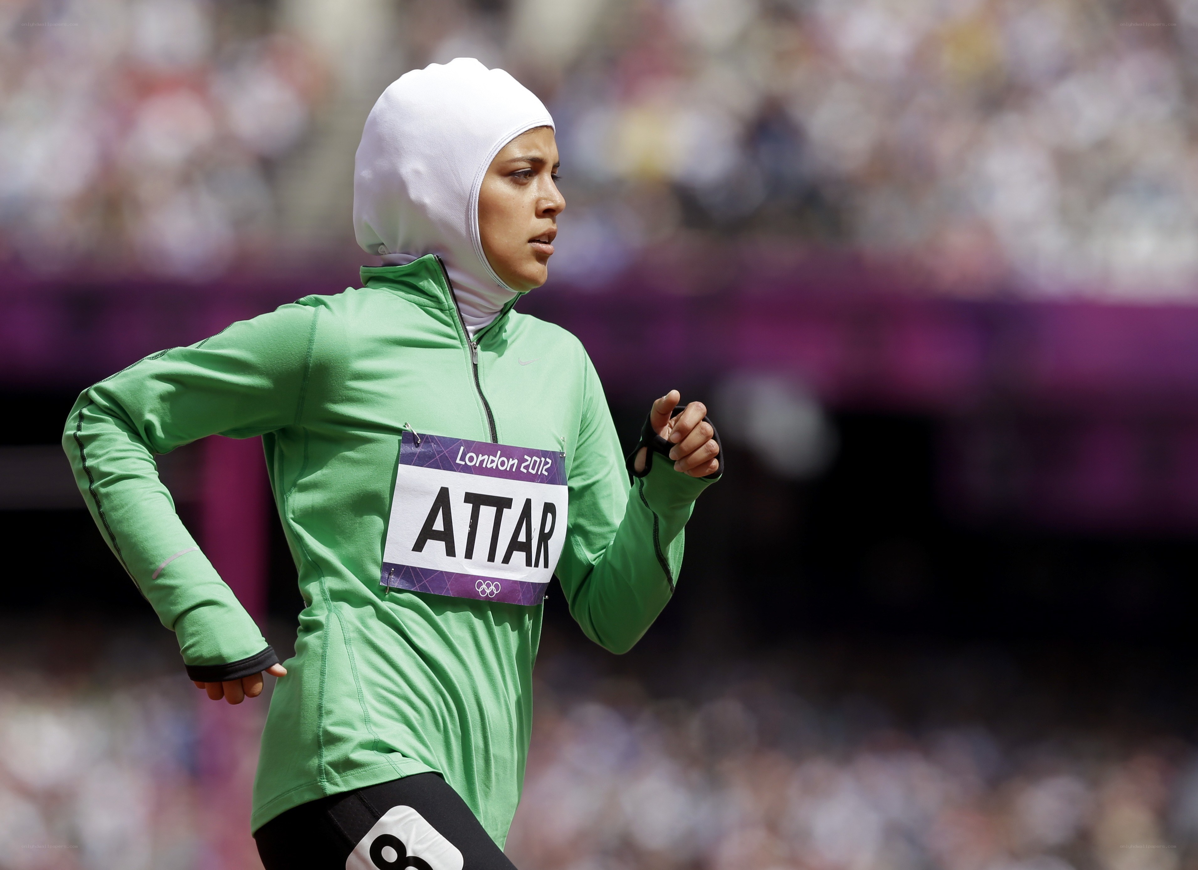 Athlete running in green jacket