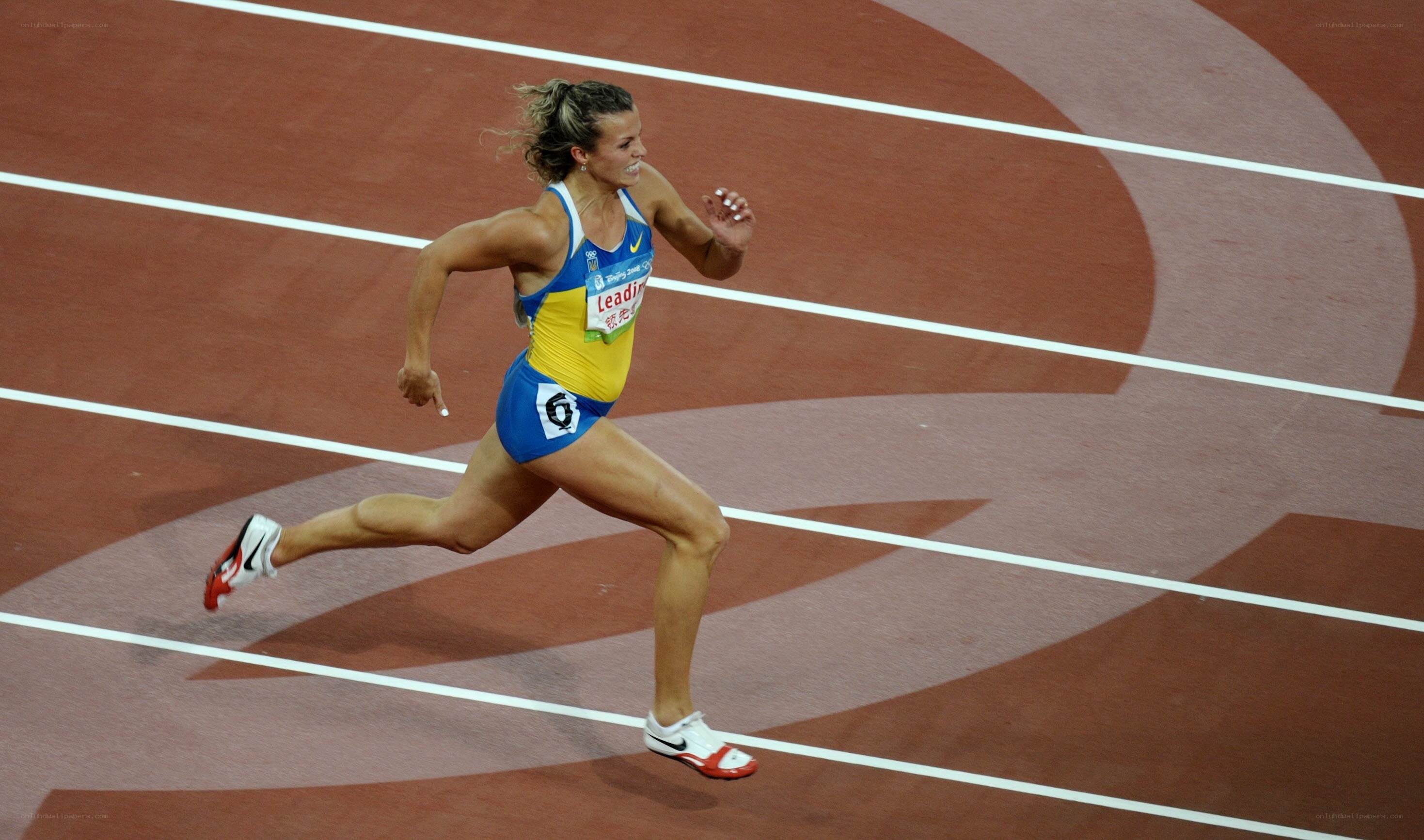 athlete running on track