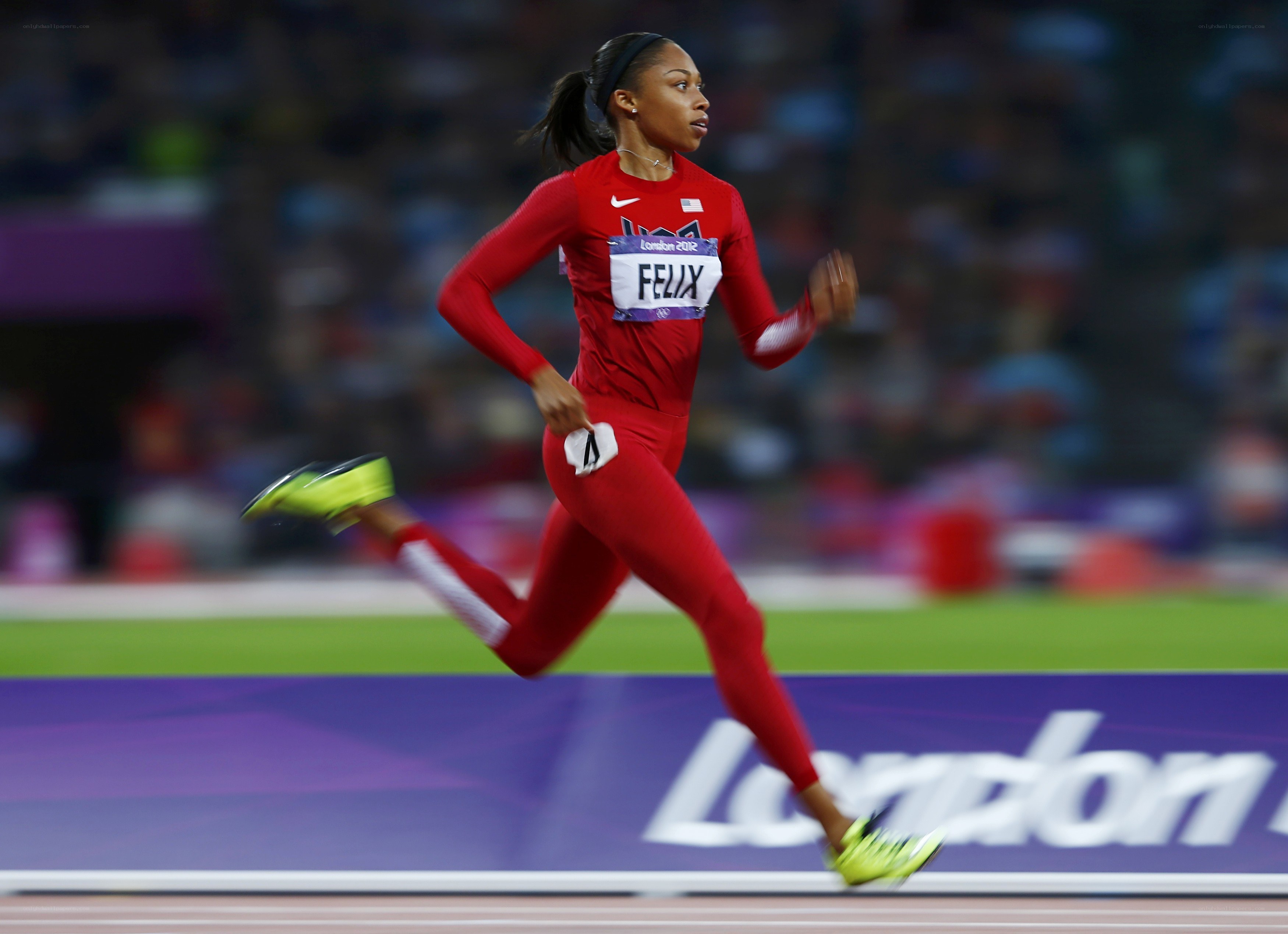 athlete running on track