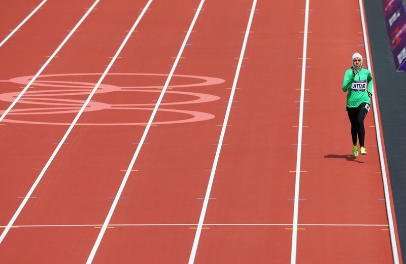 Athlete Running on Track — Red, Focused