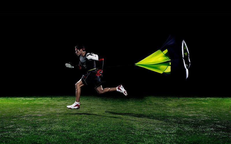 athlete running with parachute