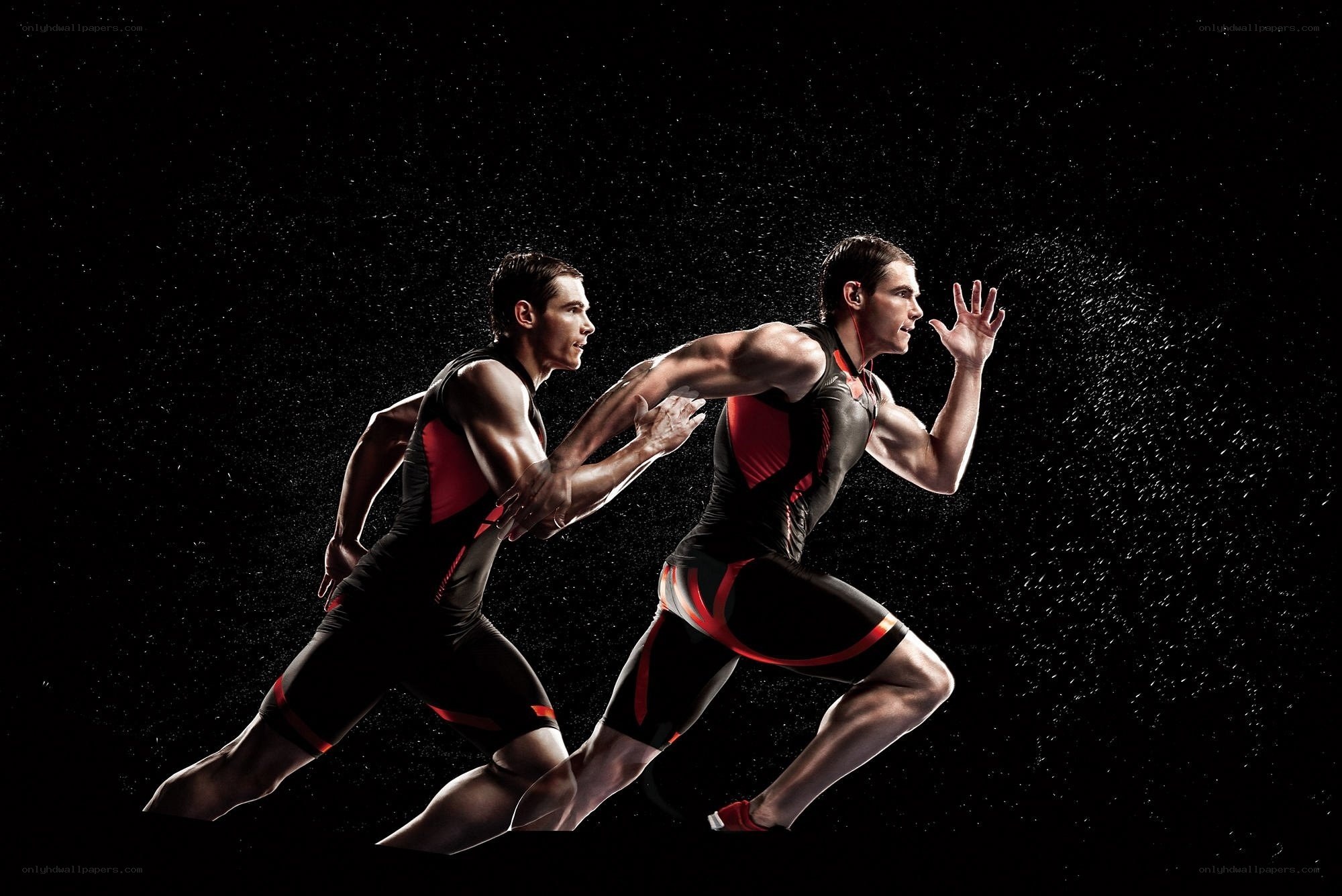 athletes running in water spray