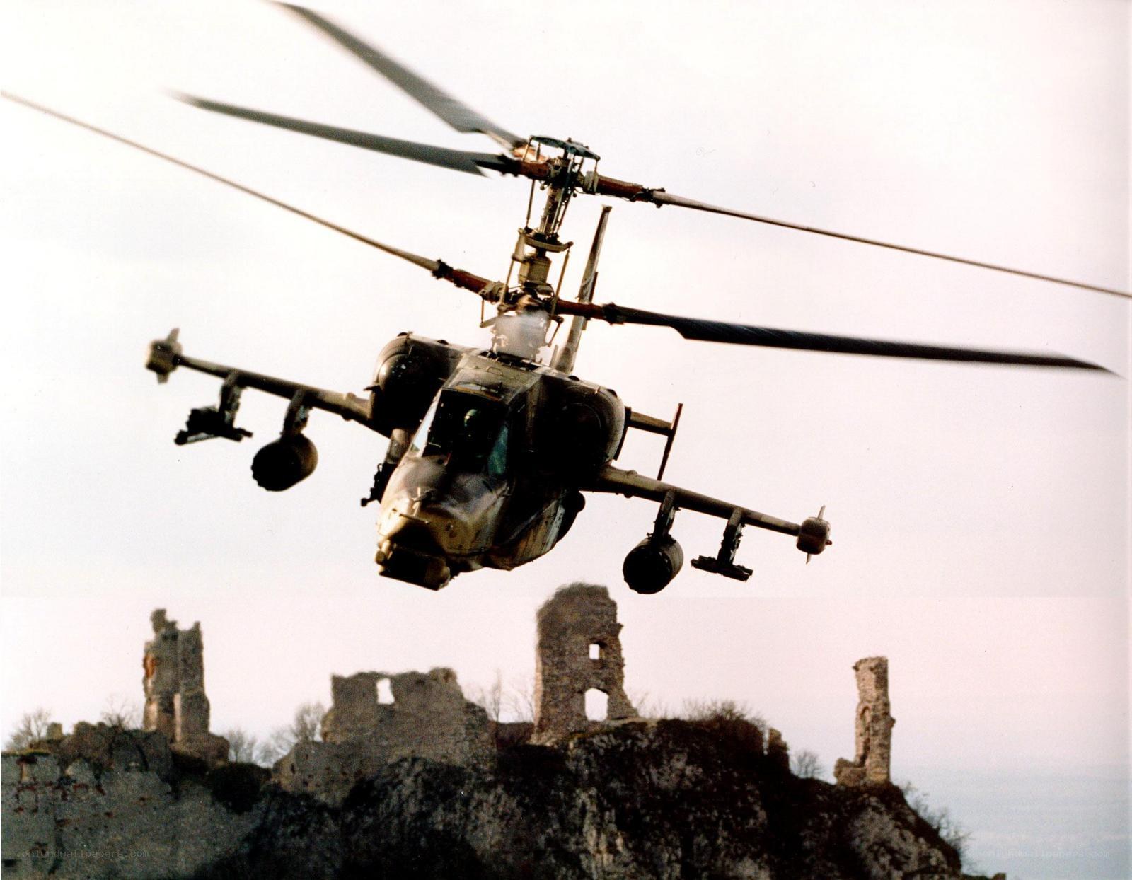attack helicopter over ruins