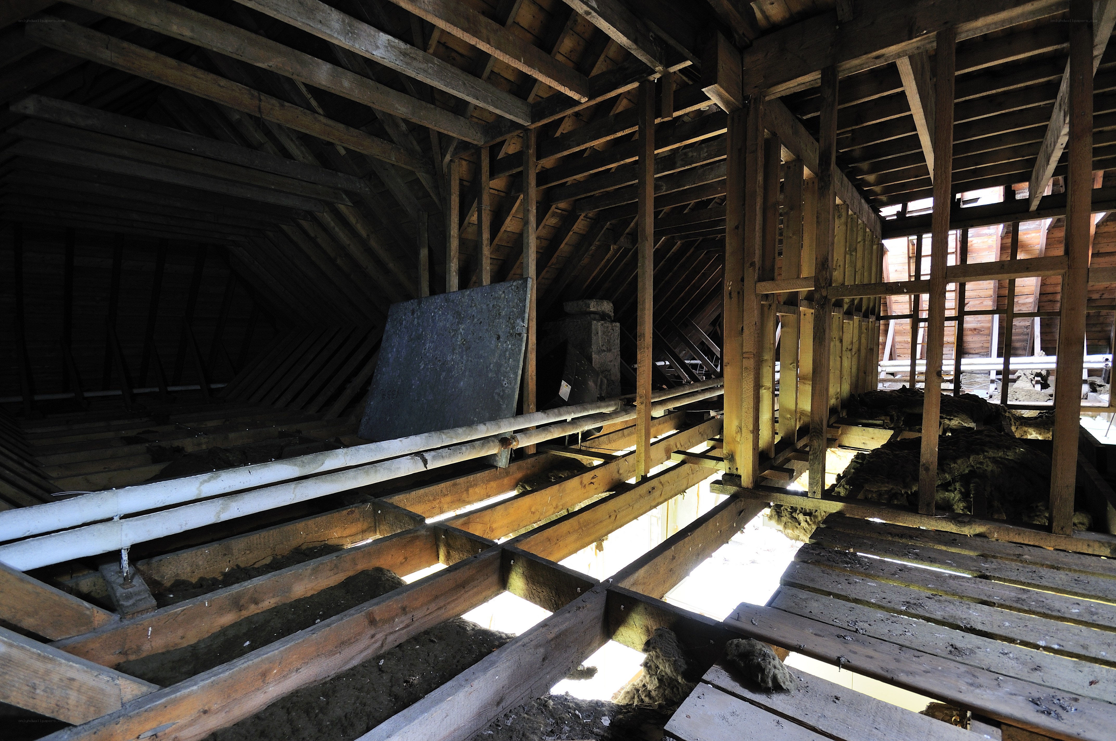 attic with exposed wooden beams