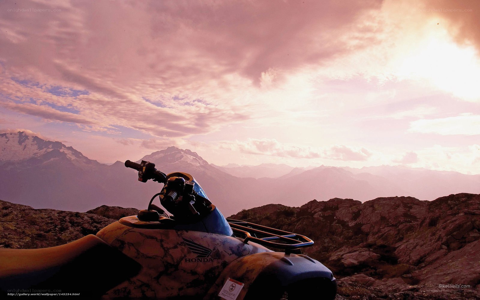 ATV on mountain peak at sunset