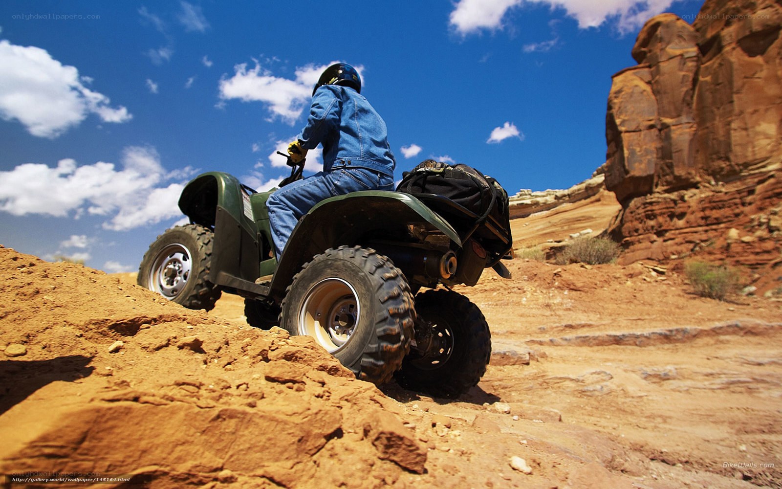ATV rider in desert canyon