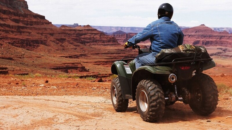 ATV rider in desert canyon