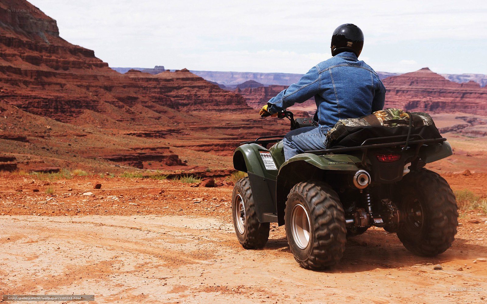 ATV rider in desert canyon