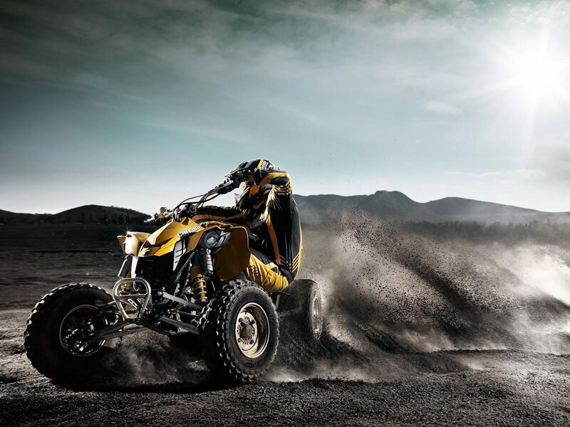 ATV rider in dusty terrain