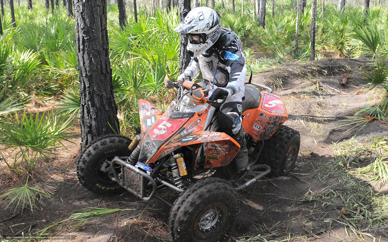 ATV rider in forest trail