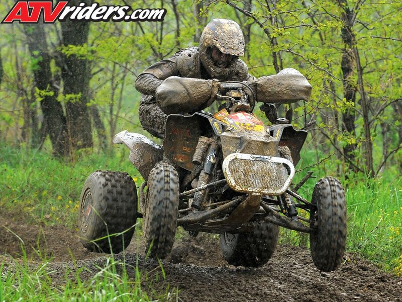 ATV rider in muddy forest