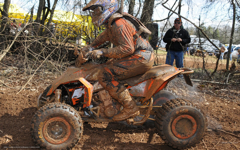 ATV rider in muddy terrain