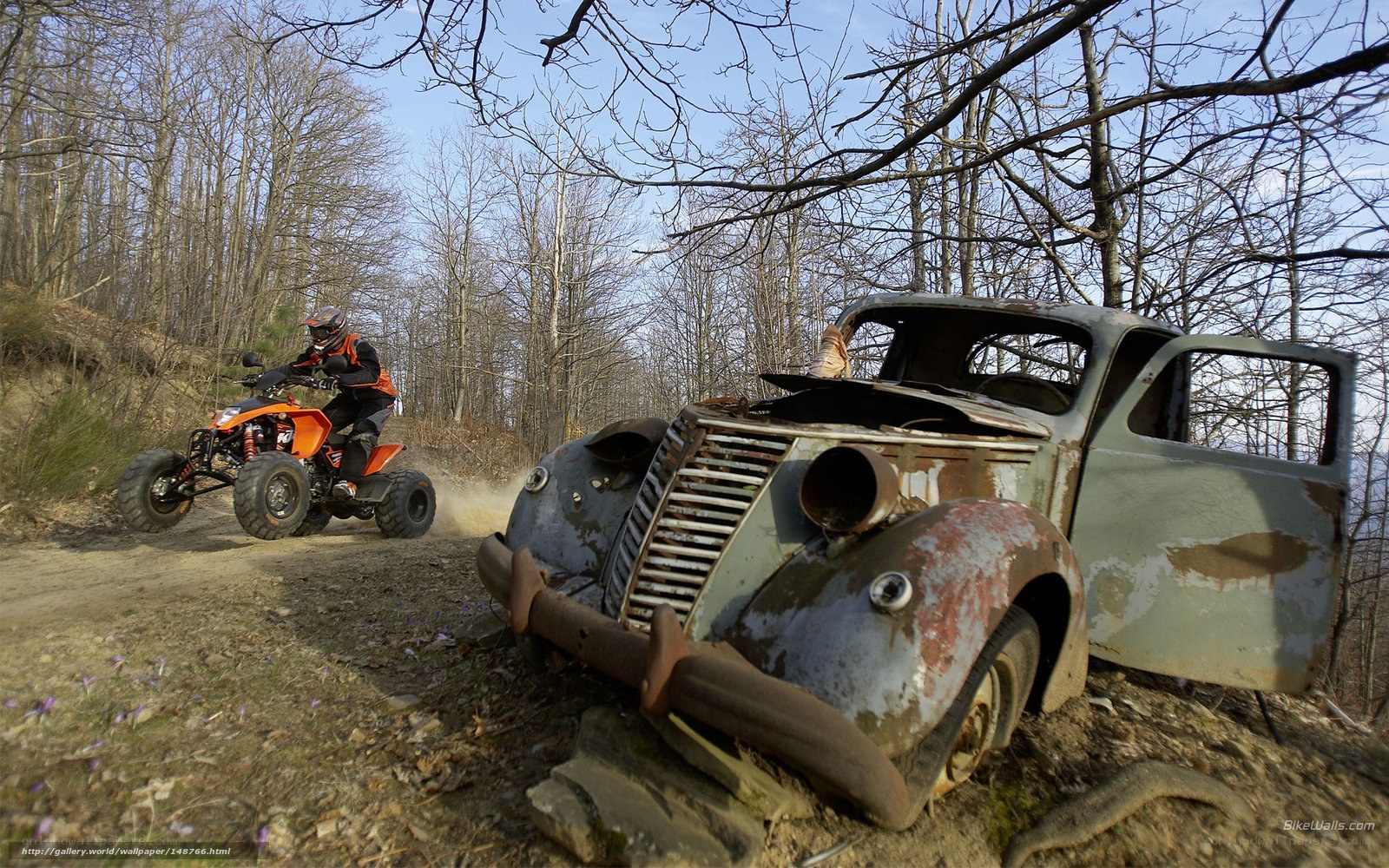 ATV rider near old car