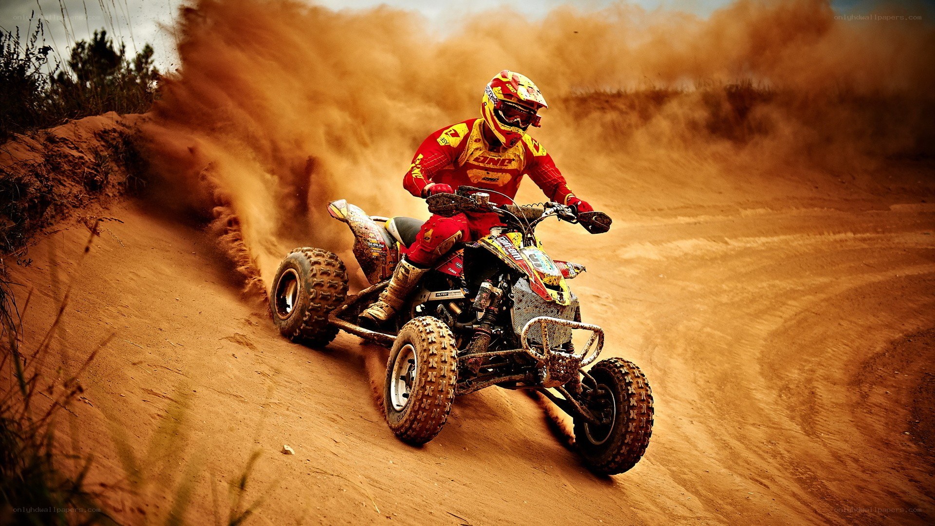 ATV rider on dusty track