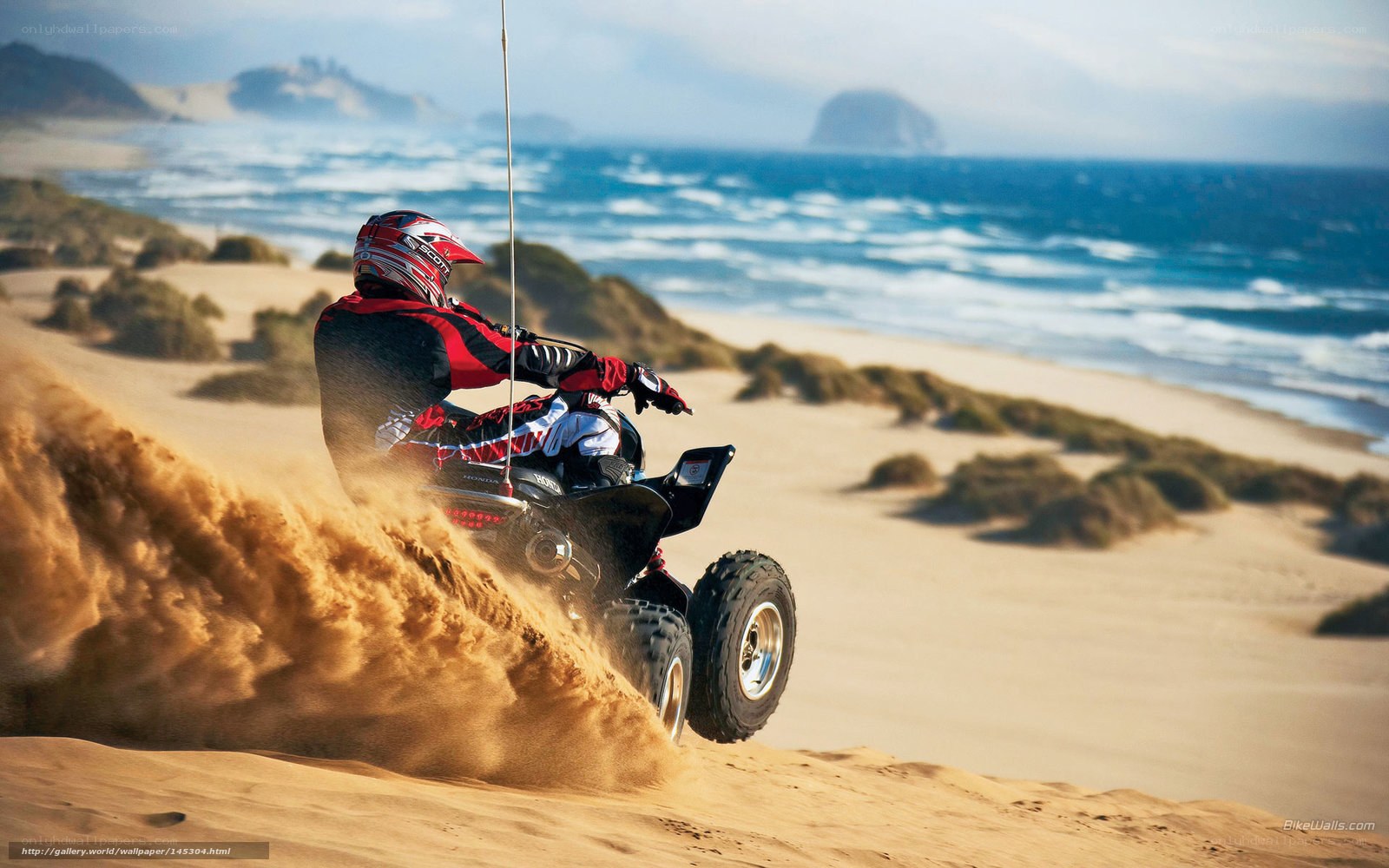 ATV rider on sandy dune