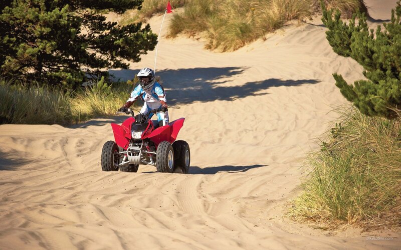ATV rider on sandy dunes