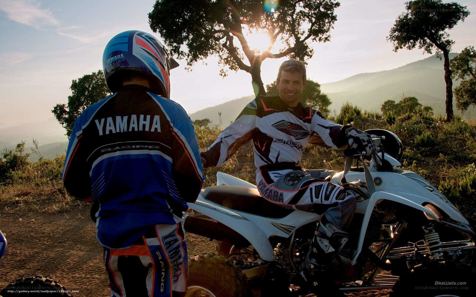 ATV riders at sunset