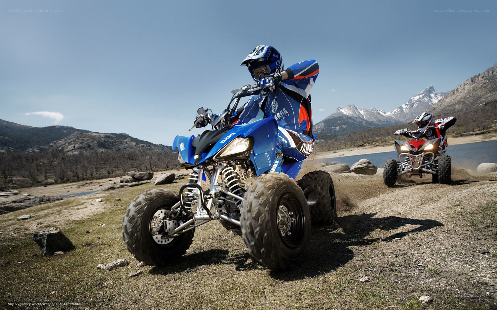 ATV riders in mountain landscape