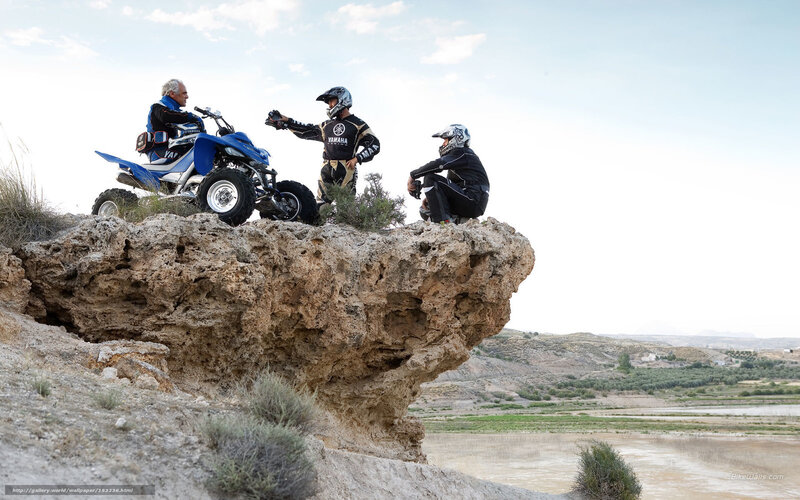 ATV riders on a cliff
