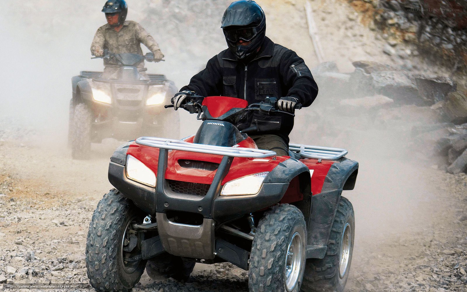 ATV riders on a dusty trail