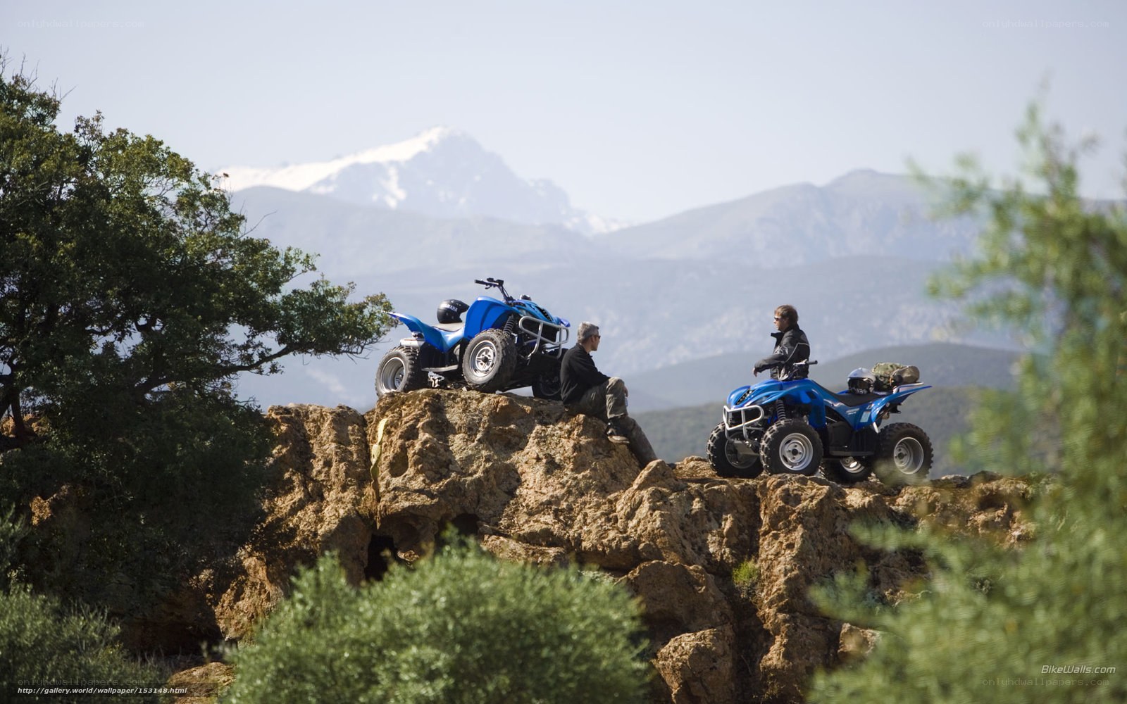 ATV riders on a mountain ridge