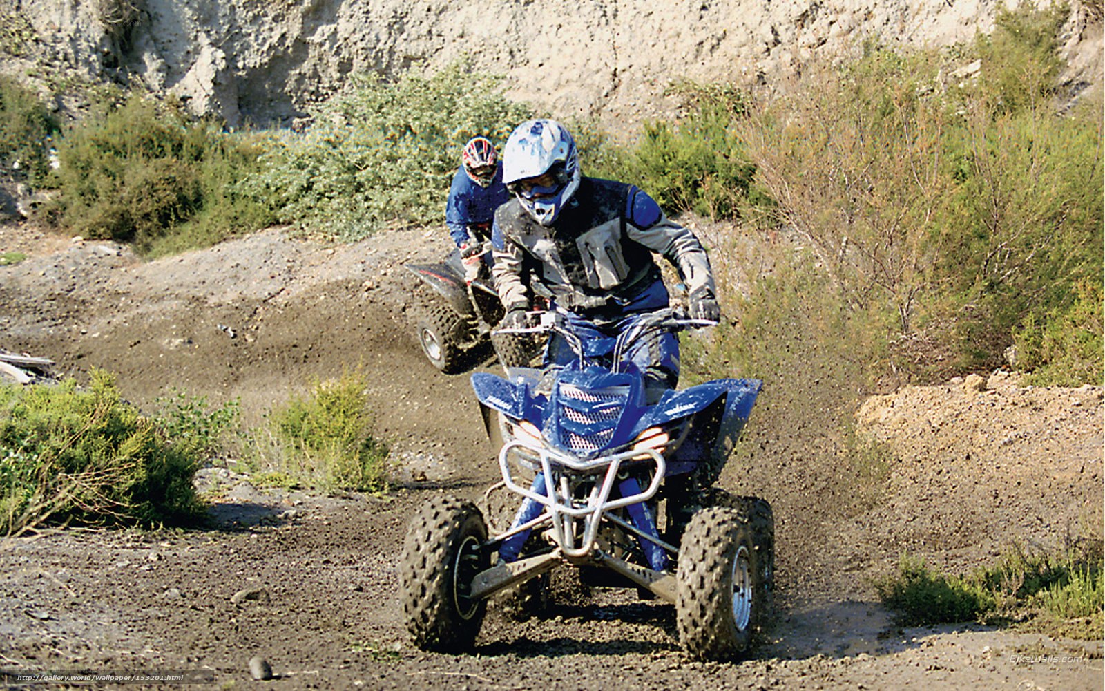 ATV riders on dirt trail