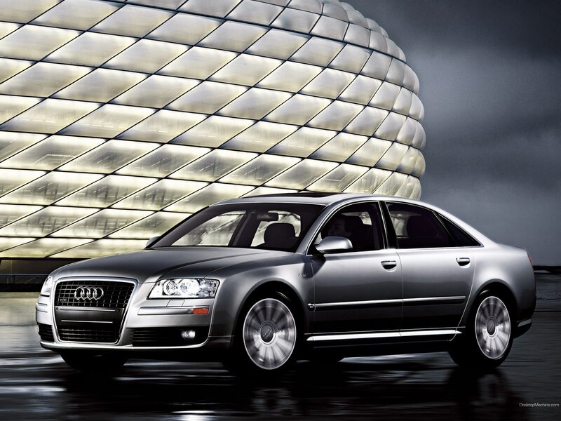 Audi A8 in front of modern building