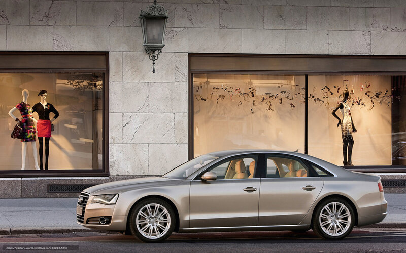 Audi A8 parked in front of a store