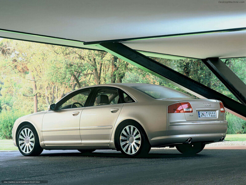 Audi A8 parked under a modern structure