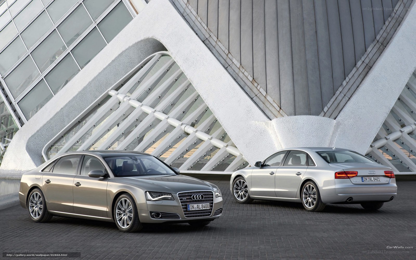 Audi A8 sedans in front of modern building