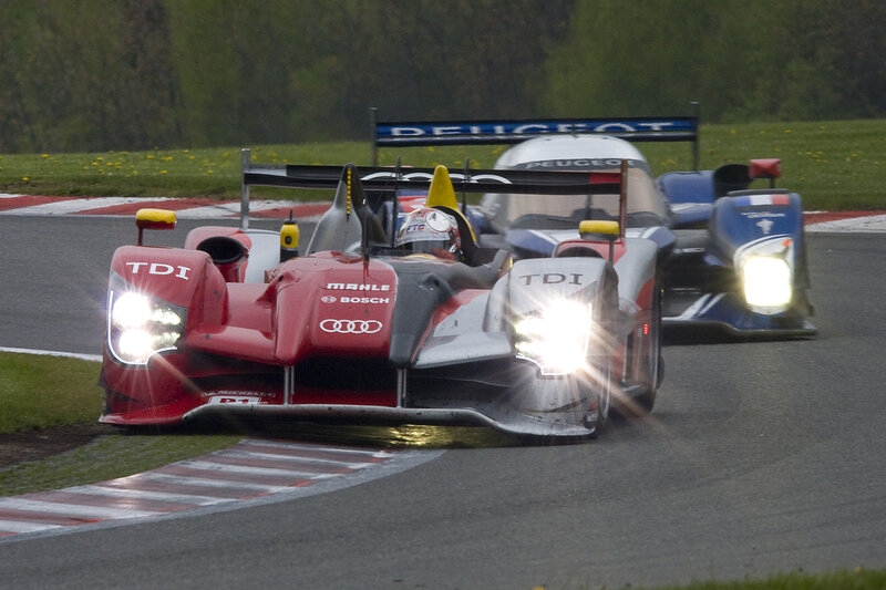 Audi and Peugeot race cars on track
